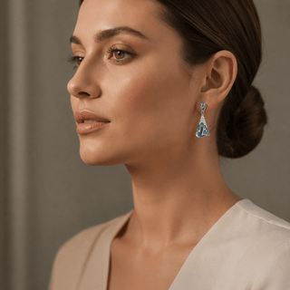 Woman wearing a pair of earrings with a neutral background